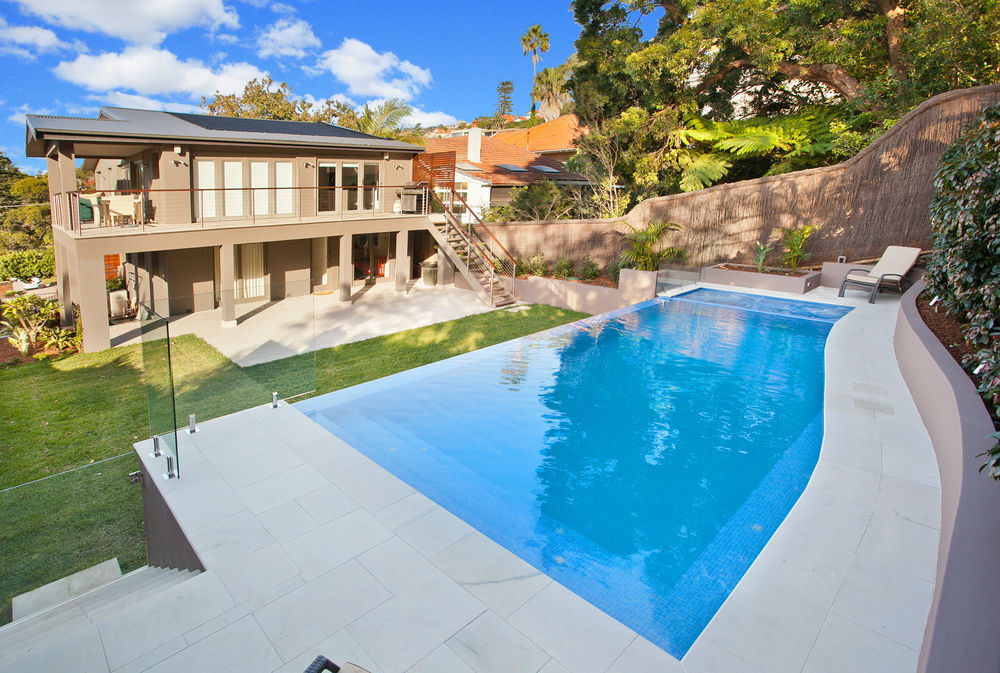 Fully tiled mid blue pool with curve and infinity edge