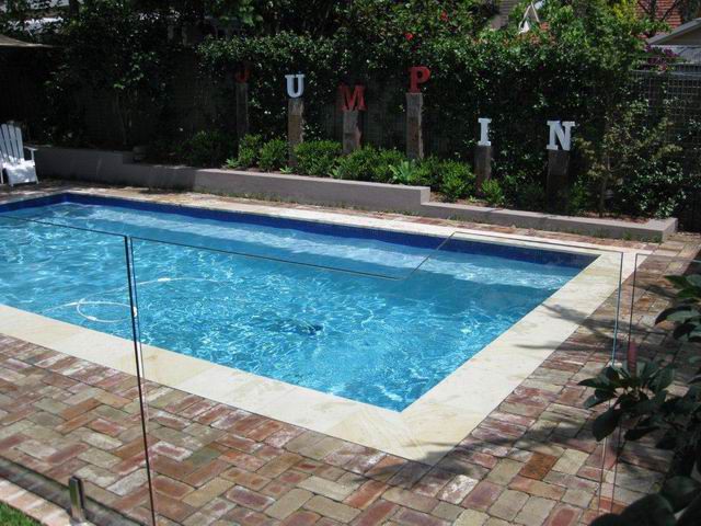 Light blue pool with recycled brick paving