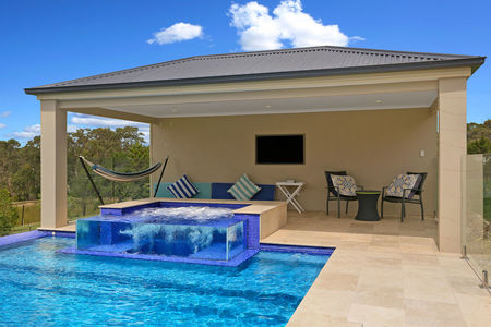 Mid blue pool in glass bead finish with raised spa and glass wall in the spa