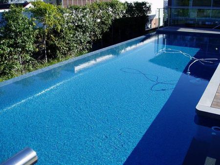 Fully tiled mid blue pool with infinity edge