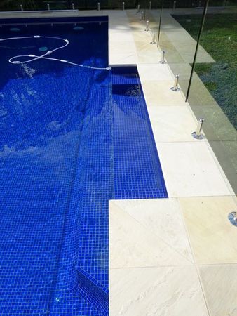 Fully tiled royal blue pool with narrow ledge