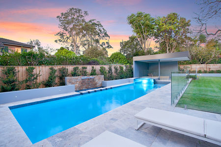 Fully tiled pool with raised spa and glass wall and water feature with stepping stones image 5