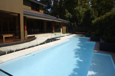 White tiled pool with ledge and spa