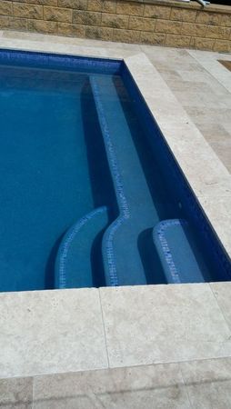 Dark blue pool with step edge tiles