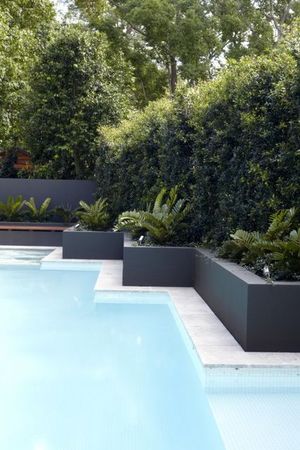 White tiled pool with rendered retaining wall stepping in and out