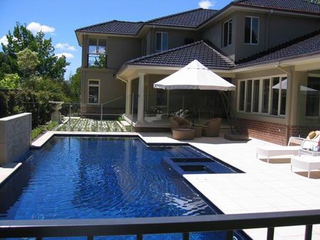 Dark blue pool and spa and feature wall