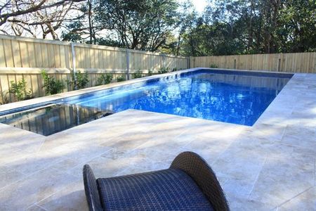 Mid blue pool with dark blue tiled spa