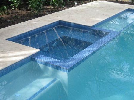 Tiled spa and light pebble pool with step edge tiles
