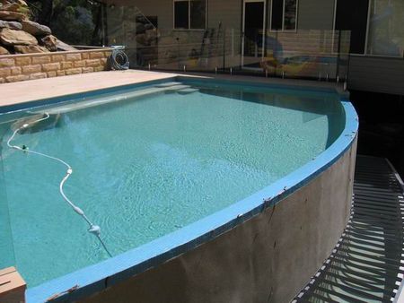 Pale green pool with curved infinity edge