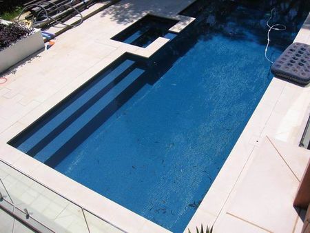 Fully tiled dark blue pool and spa large steps