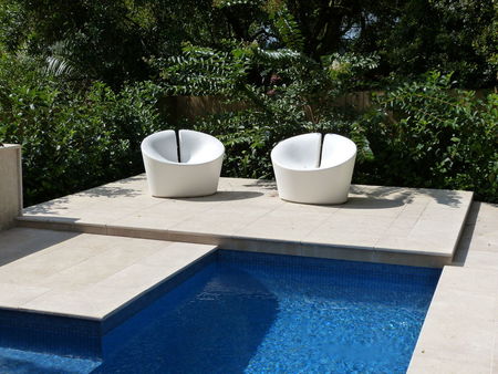 Raised platform with chairs at the end of a pool