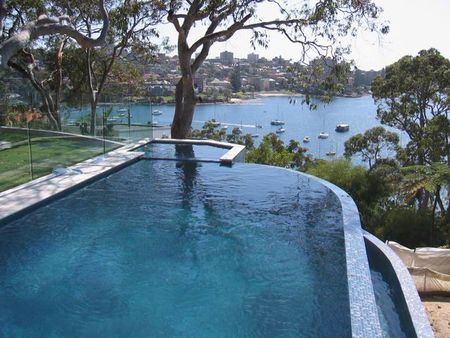 Infinity edge green pool and spa overlooking harbour