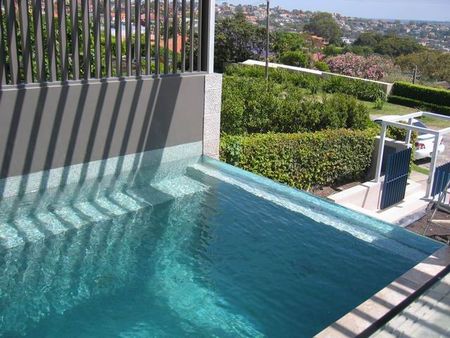 Tiled plunge pool with glass edge infinity