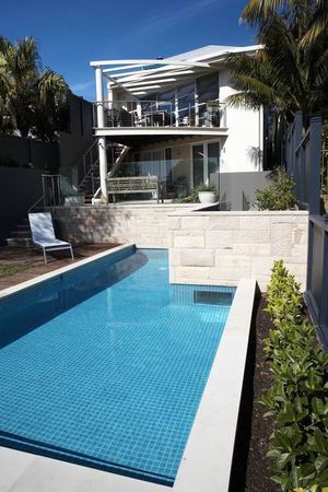 Tiled pool with integral wall sandstone cladding and pool window