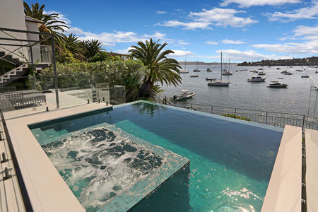 Fully tiled green pool and spa with infinity edge overlooking sydney harbour image 1