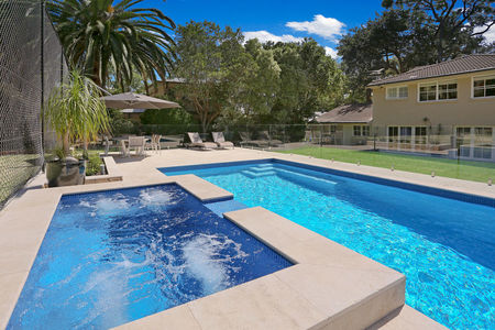 Bright blue pool with raised spa