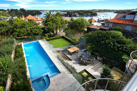 Fully tiled sky blue pool with curved spa and water features