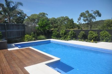 Mid blue pool with deck and ledges